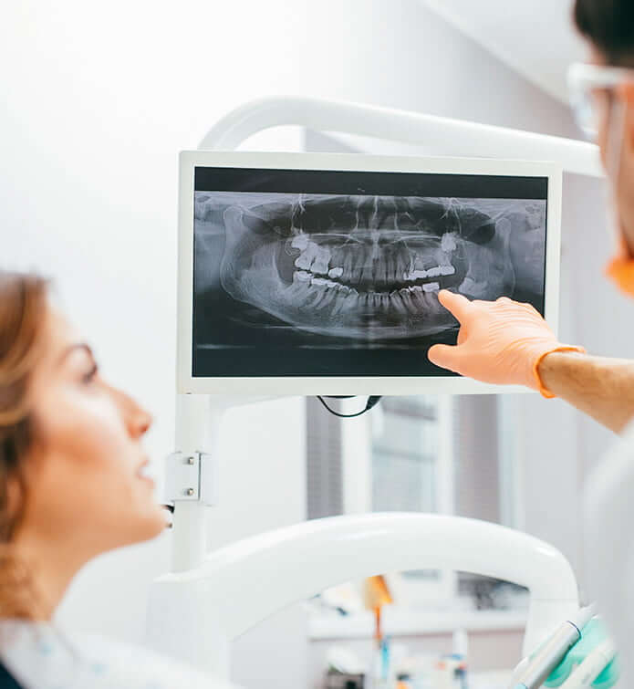 woman at the dentist looking at xrays