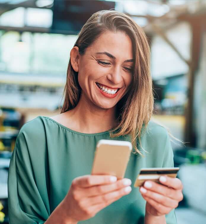 smiling woman looking at phone