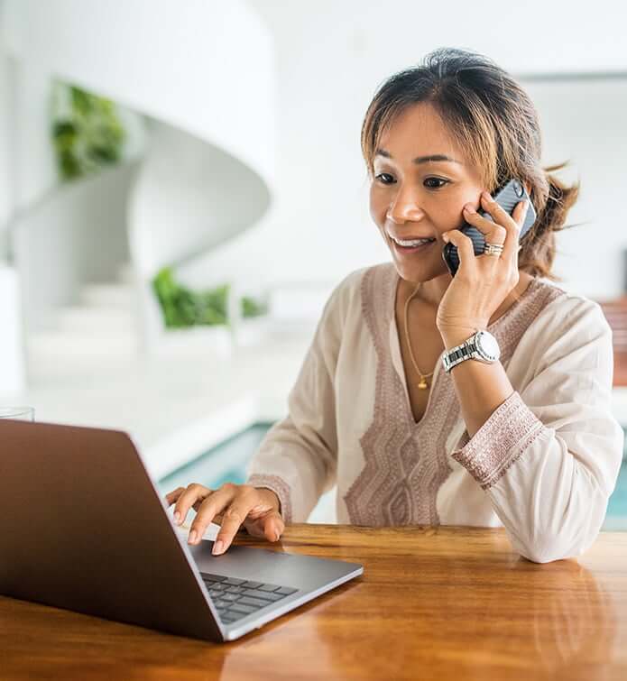 woman on cell phone and computer