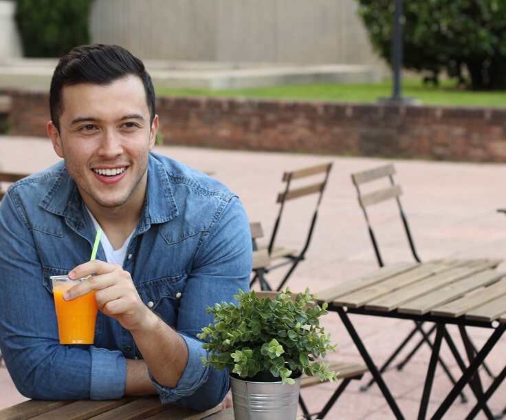 man outside with a drink