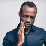 man with tooth pain from a toothache