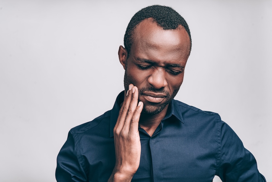 man with tooth pain from a toothache